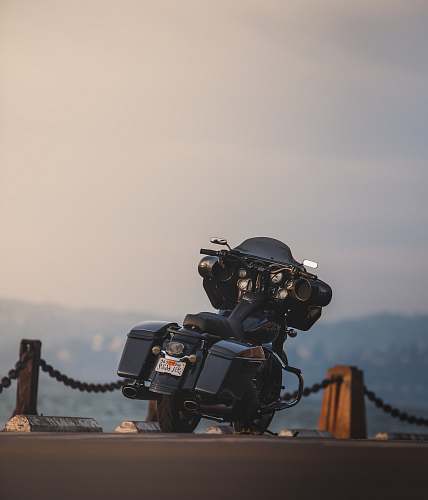 fort point black touring motorcycle parked on dock during daytime san francisco